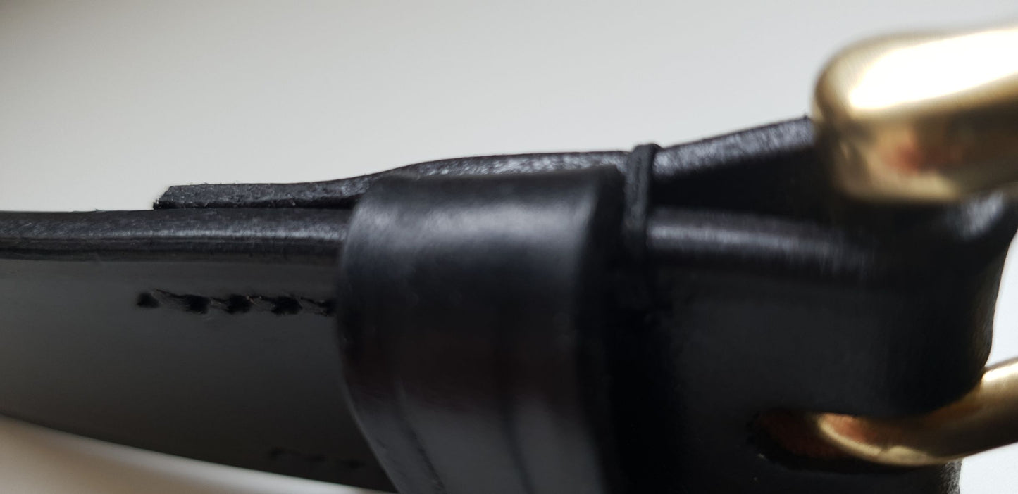 Polished edge of black bridle leather belt
