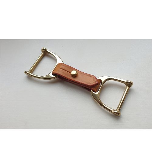 Close-up of handcrafted solid brass stirrup buckles on leather scarf belt